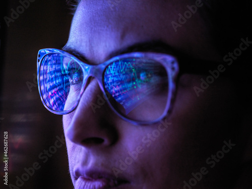 Female analyst viewing financial market data on a screen