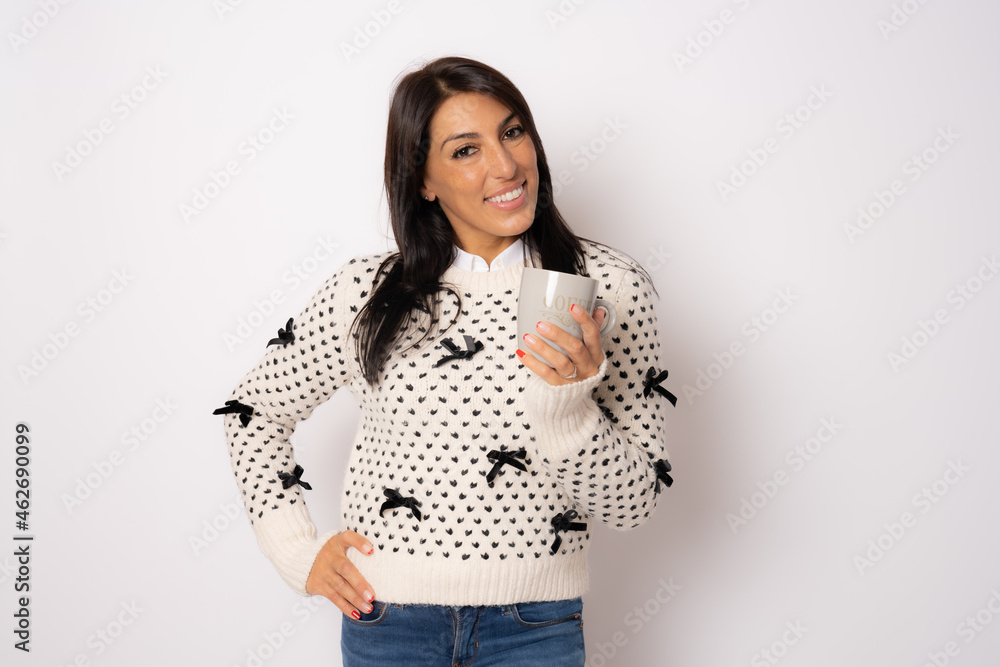 Photo of beautiful young woman standing isolated over white background. Looking camera drinking tea. Photo of beautiful young woman standing isolated over white background. Looking camera drinking tea.