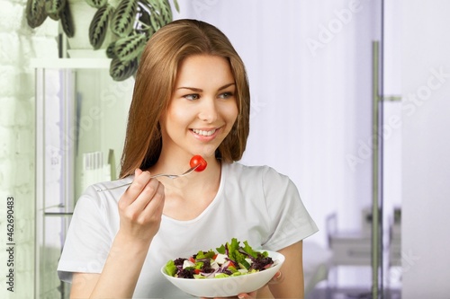 Portrait of attractive woman hold salad bowl and look at camera.