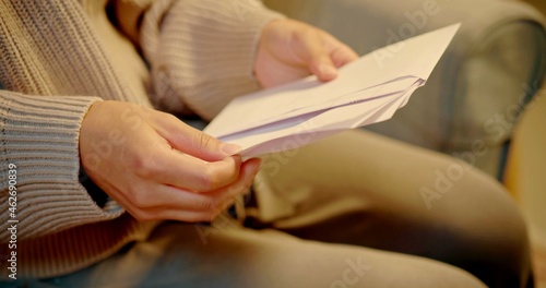 A woman is opening a letter