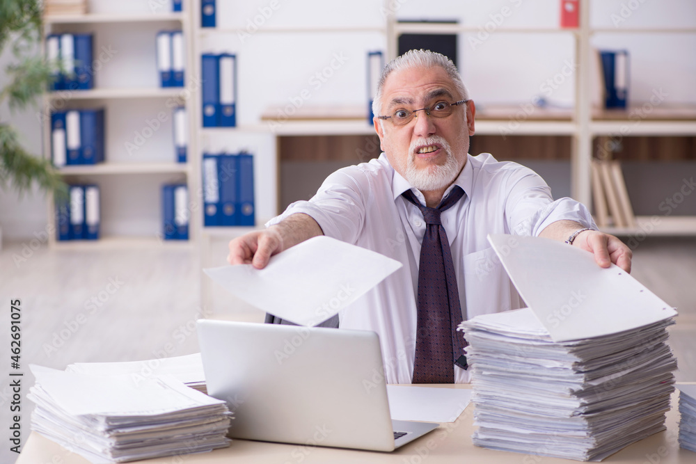 Old male employee and too much work in the office Old male employee and too much work in the office