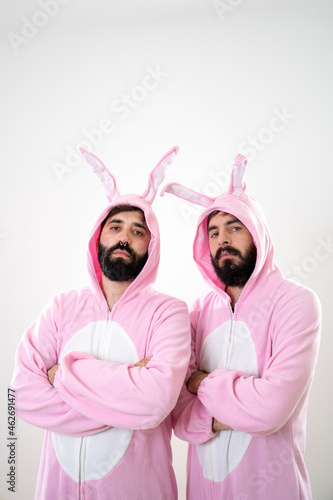 Two male friends with rabbit costumes in front of white background photo