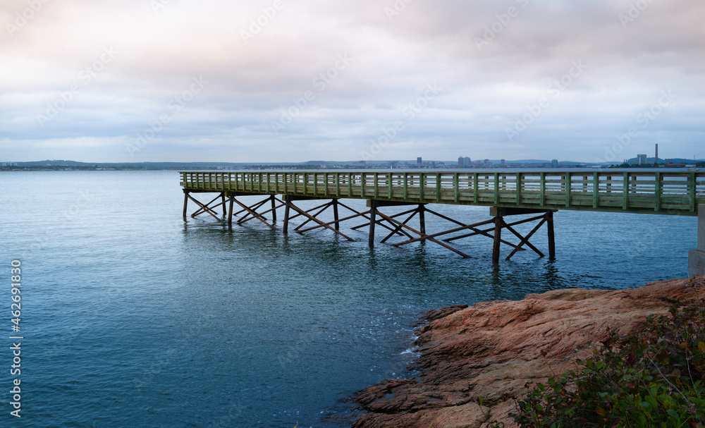 Empty Pier over the rocky cliff stretching out into New Haven Harbor in Connecticut Empty Pier over the rocky cliff stretching out into New Haven Harbor in Connecticut
