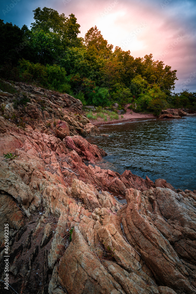 Bright sunrise over the rocky cliff at Lighthouse Point Park in New Haven, Connecticut