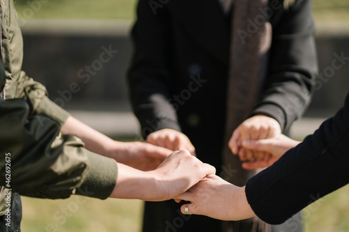 Close-up of three women holding their hands photo