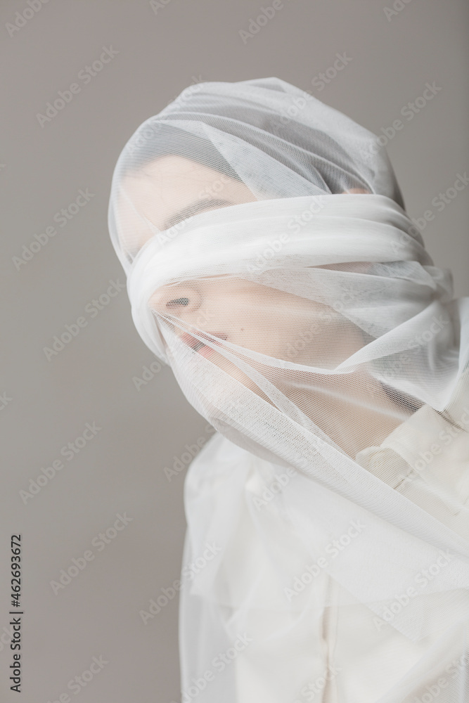 Blindfold woman, wrapped in a veil