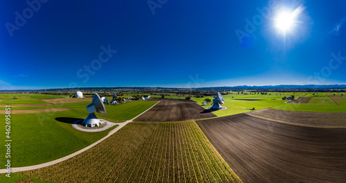 Germany, Bavaria, Aerial view of large parabolic antennas of the earth station Raisting and green fields photo