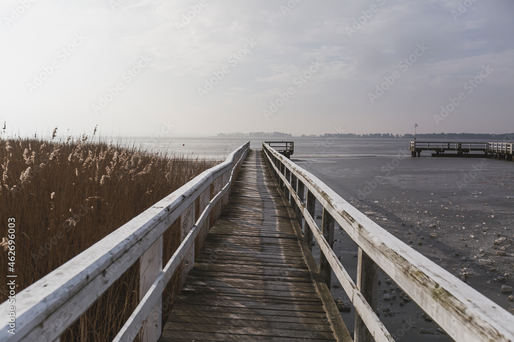 Germany, Mecklenburg-Western Pomerania, Wieck, wooden boardwalk in winter, frozen bodden Germany, Mecklenburg-Western Pomerania, Wieck, wooden boardwalk in winter, frozen bodden