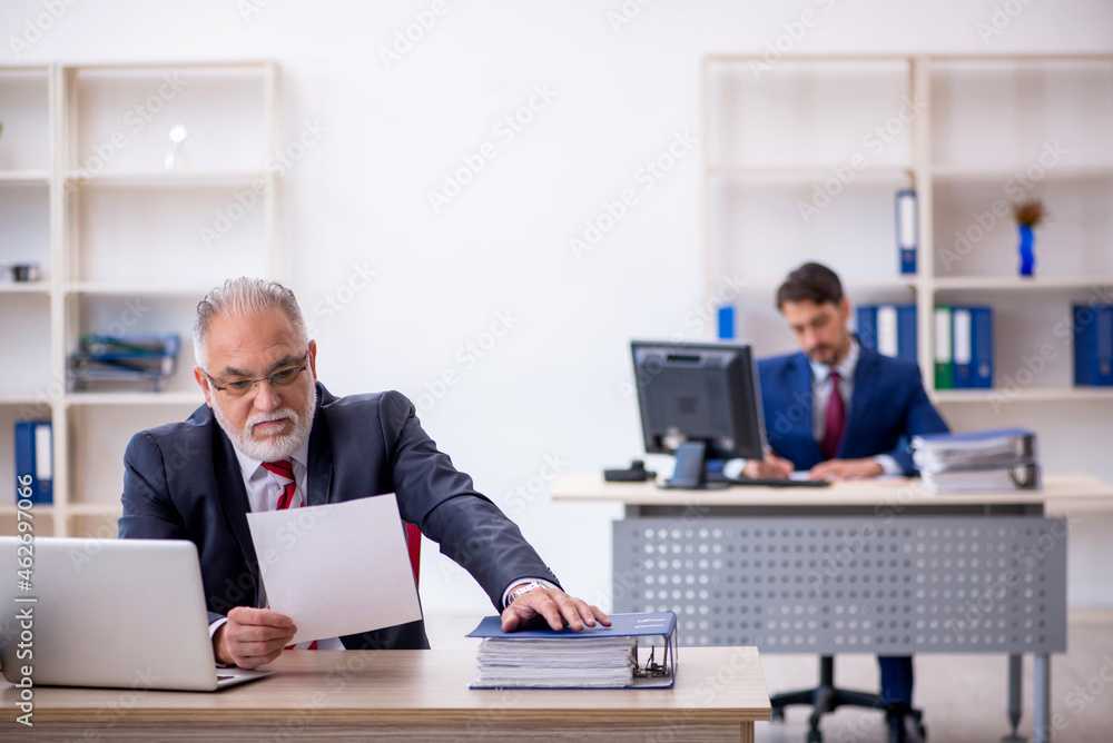 Two male colleagues working in the office Two male colleagues working in the office