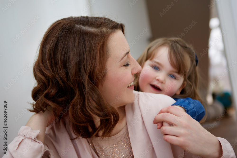 Happy young mother playing with her little daughter at home Happy young mother playing with her little daughter at home