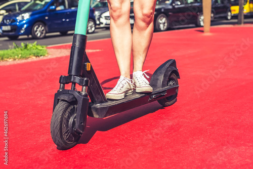 Legs of young woman riding E-Scooter on Boulevard of the Stars, Berlin, Germany photo