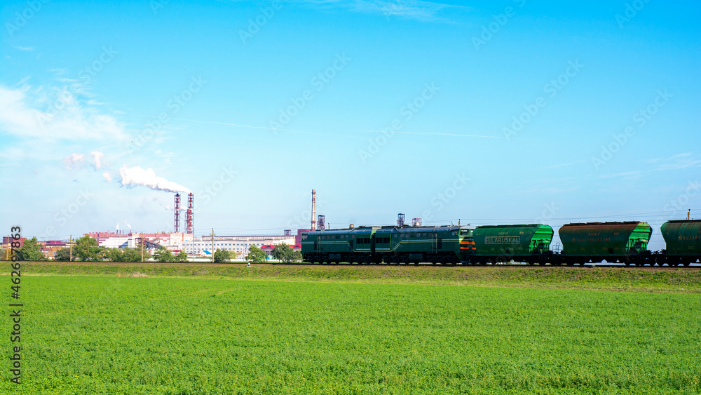 Freight train, Belaruskali hopper wagon with edible salt from largest Belarus producers of potash fertilizers in the world. Cargo train delivers goods. Export of edible salt