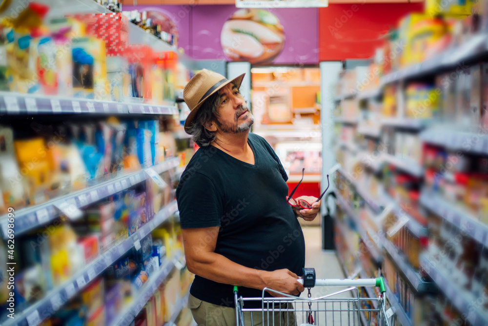 Senior man shopping in a supermarket