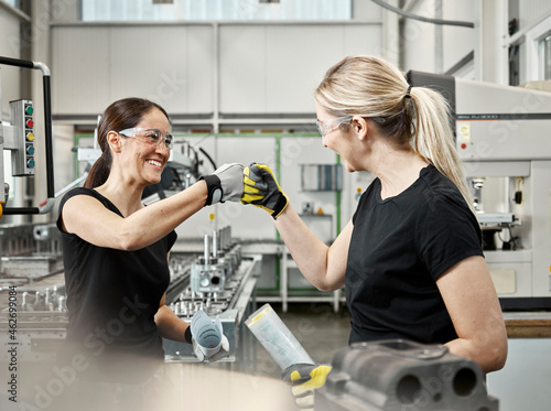 Two woman at work, fist bump