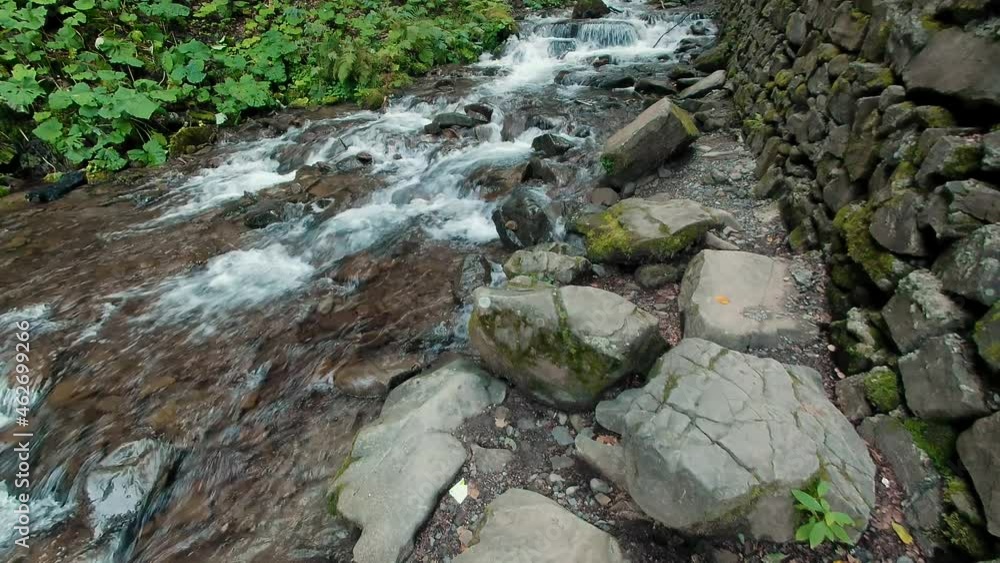 Waterfall stream running fast in mountain green forest Waterfall stream running fast in mountain green forest