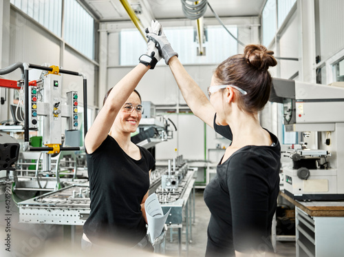 Two women at work, high five photo