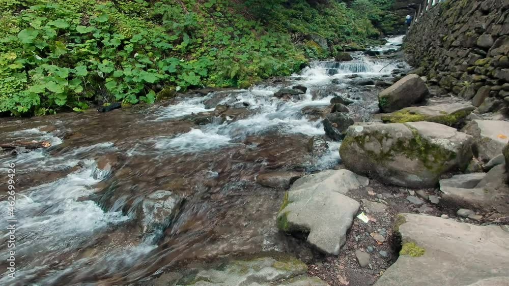 Waterfall stream running fast in mountain green forest Waterfall stream running fast in mountain green forest