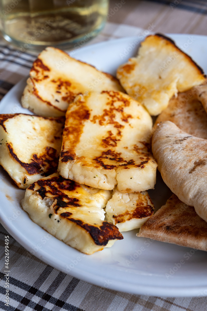 Traditional roasted or grilled halloumi cheese from Cyprus served hot with flat bread Traditional roasted or grilled halloumi cheese from Cyprus served hot with flat bread