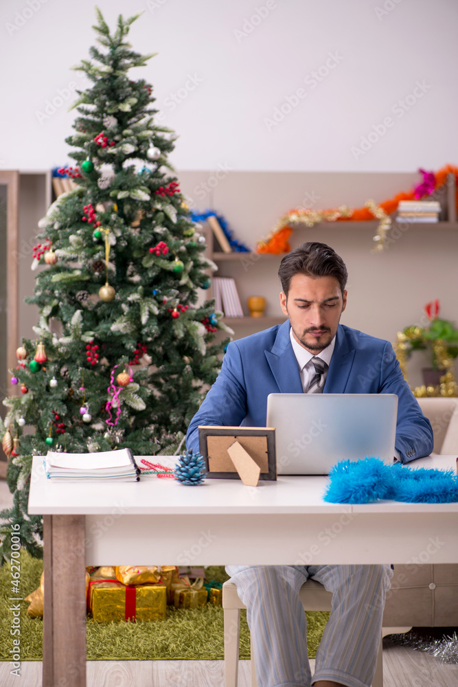 Young businessman working from home at Christmas eve Young businessman working from home at Christmas eve