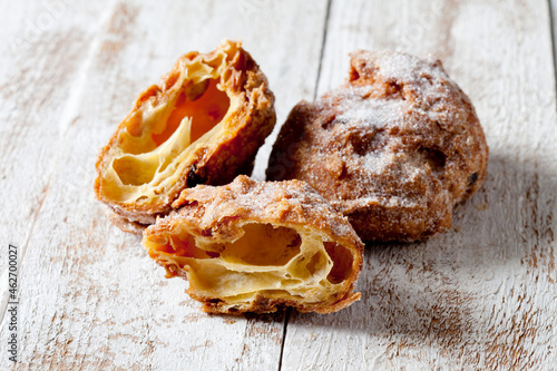 Choux pastry crullers on white wood photo