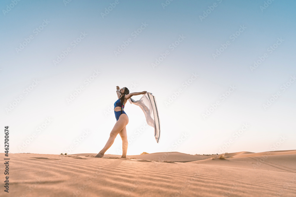 Beautiful young woman in swimsuit in the desert, Merzouga, Morocco Beautiful young woman in swimsuit in the desert, Merzouga, Morocco