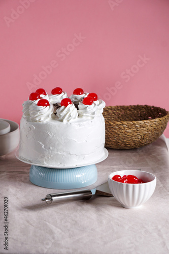 Schwarzwalder Kirschtorte, black forest cake, harsh light, table background in sunlight, modern still life, cherry dessert on modern background photo