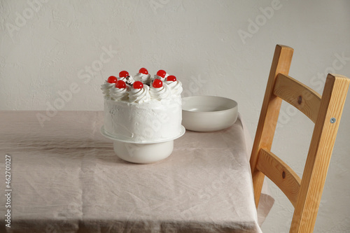 Schwarzwalder Kirschtorte, black forest cake, harsh light, table background in sunlight, modern still life, cherry dessert on modern background photo