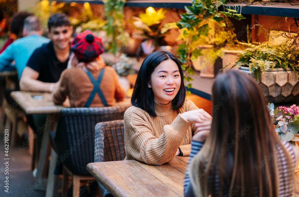 Friends having drinks in a restaurant, talking Friends having drinks in a restaurant, talking
