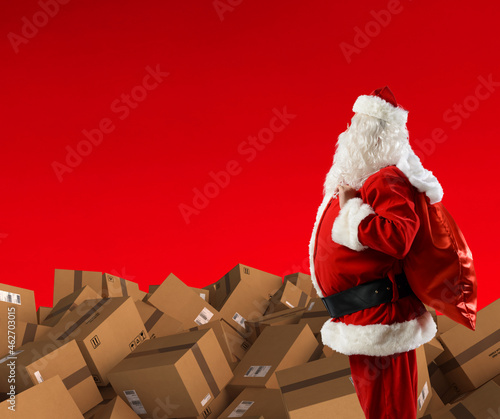 Santa claus with a lot cardboard to deliver