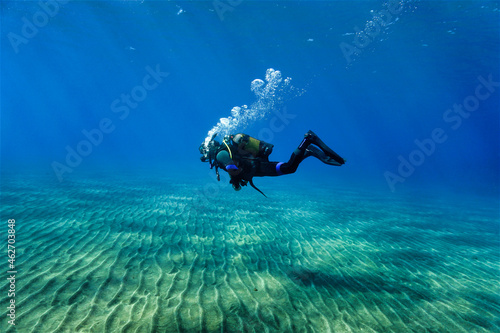 scuba diver in the sea and crystal clear water