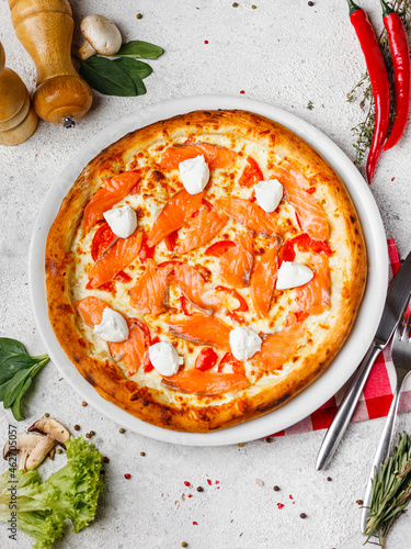 fast food, appetizing tasty pizza with ingredients on a light background