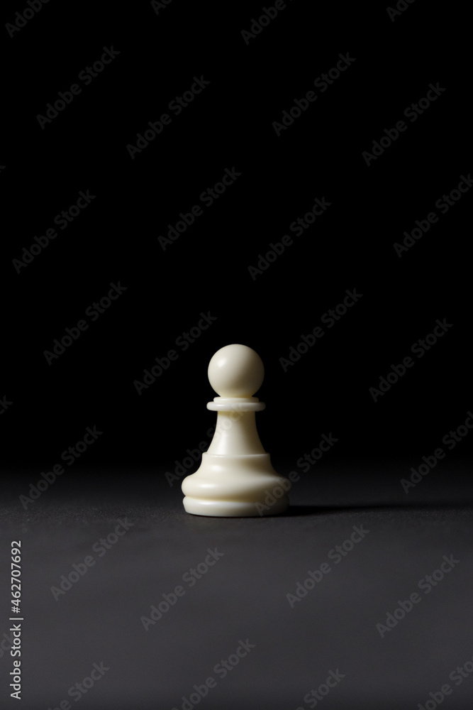 isolated white pawn chess piece on black background isolated white pawn chess piece on black background