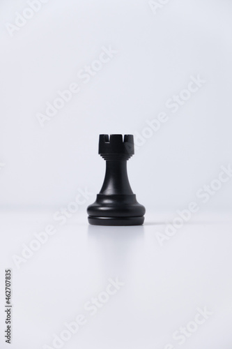 isolated black rook chess piece on white background
