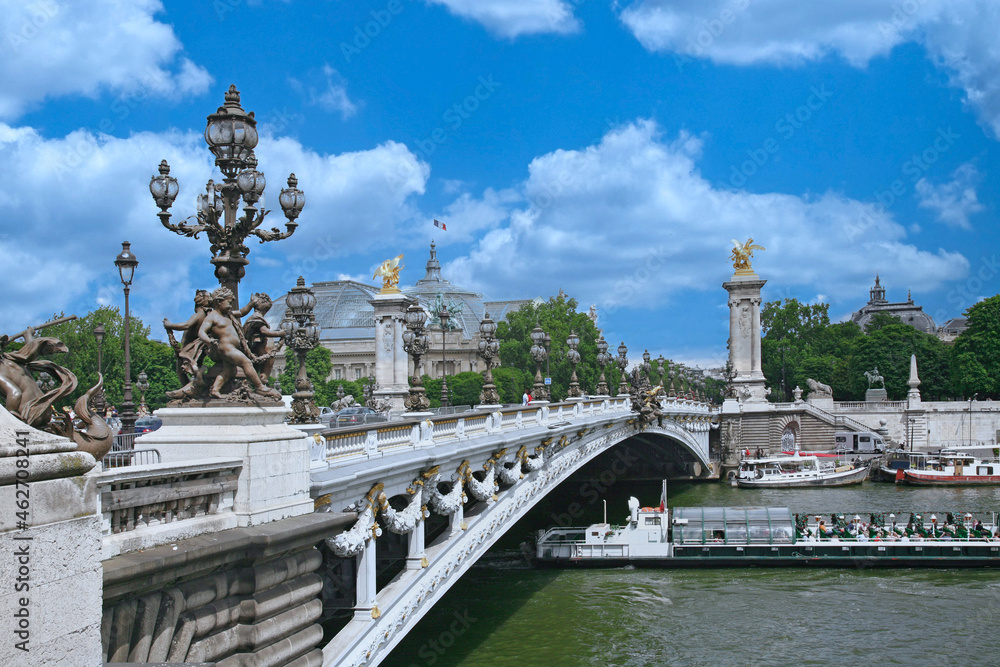 Paris, boats on the Seine and ornate decorations on the Alexander Bridge