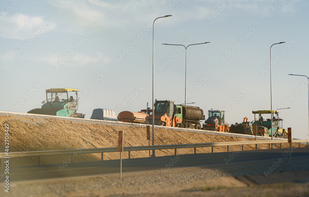 Road construction machinery stands on the bridge. Road construction machinery stands on the bridge.