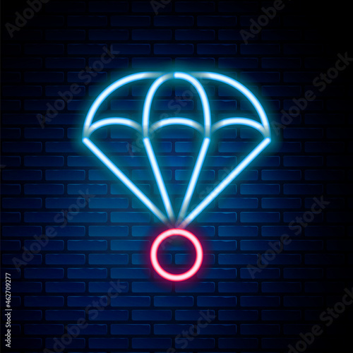 Glowing neon line Parachute icon isolated on brick wall background. Extreme sport. Sport equipment. Colorful outline concept. Vector