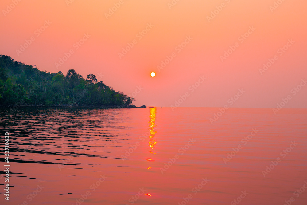 Bright sunset over the sea and the mountain. Evening sea landscape. Travel and tourism.