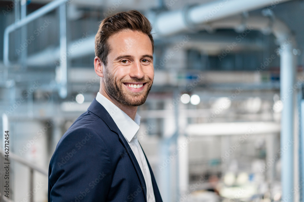 Portrait of a smiling businessman in a factory Portrait of a smiling businessman in a factory