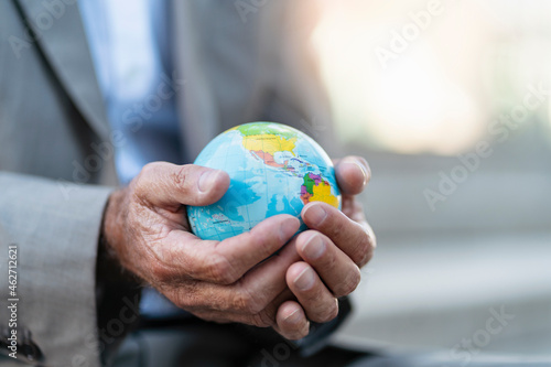 Close-up of hands of businessman holding globe photo