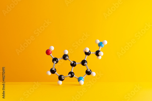 Caffeine formula's molecular structure over yellow background photo