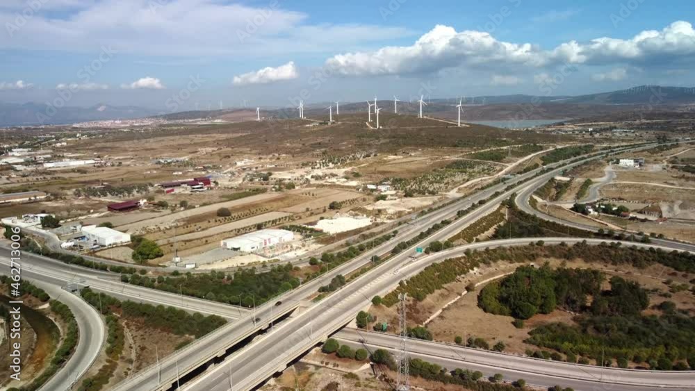 Aerial view over the farm landscape and wind turbines generating clean renewable energy. Renewable energy production for the green ecological world. High quality 4k footage Aerial view over the farm landscape and wind turbines generating clean renewable energy. Renewable energy production for the green ecological world. High quality 4k footage