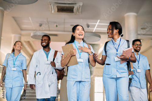 Fotografie Happy multi-ethnic group of medical students have fun while talk in hallway at the university