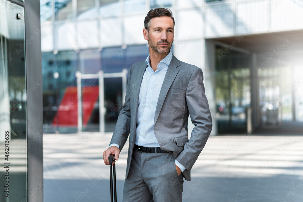 Portrait of confident businessman with baggage Portrait of confident businessman with baggage