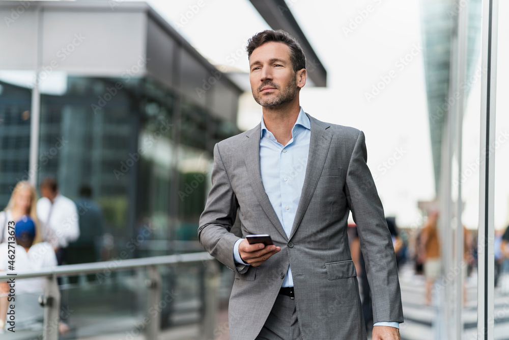 Portrait of businessman with cell phone on the go Portrait of businessman with cell phone on the go