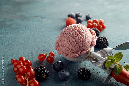 Raspberry ice cream on scoop and fresh fruits photo