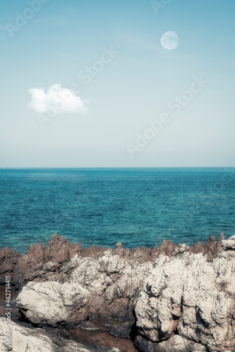 Spain, Balearic Islands, Canyamel, Rocky shore of Mediterranean Sea with clear line of horizon in background photo