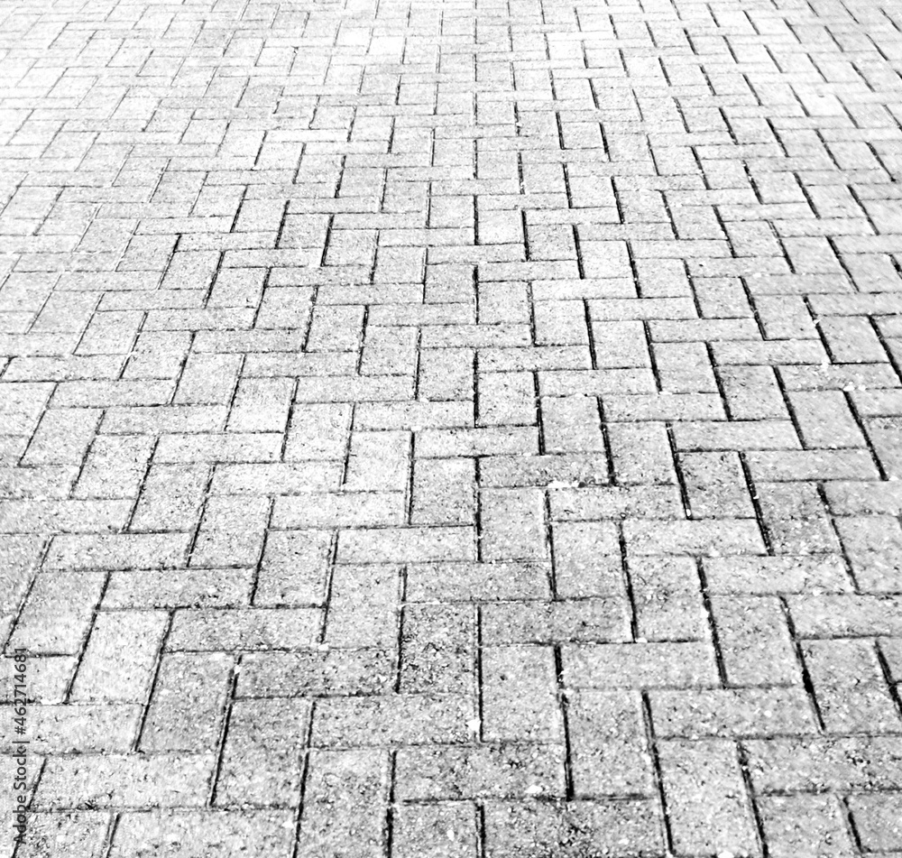 Full frame texture image of monochrome herringbone paving blocks with copy space