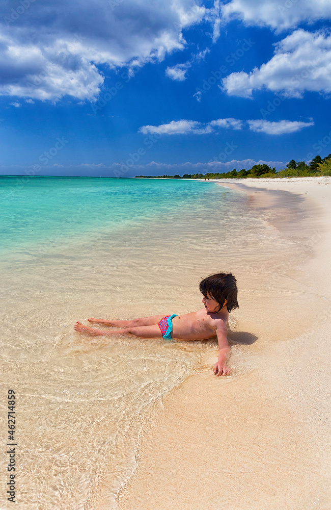Shirtless girl playing on sea shore at beach during summer vacation, Punta Sur, Cozumel, Mexico Shirtless girl playing on sea shore at beach during summer vacation, Punta Sur, Cozumel, Mexico