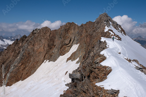 Panoramic view on the main Stubai mountain ridge with Wilder Freiger summit and Sulzenau glacier in Tyrol Alps. Climbers on the summit. Border between Austria and Italy in Tyrol Alps. photo