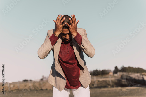Desperate young man standing outdoors
